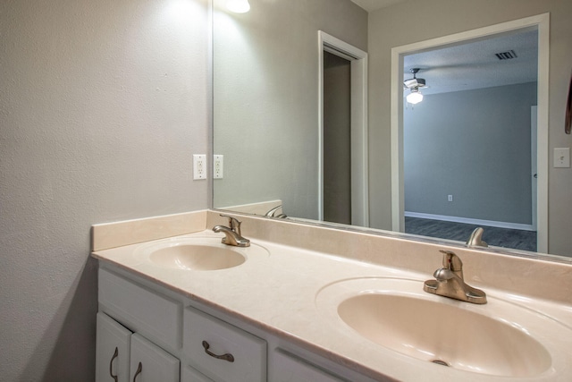 bathroom with ceiling fan and vanity