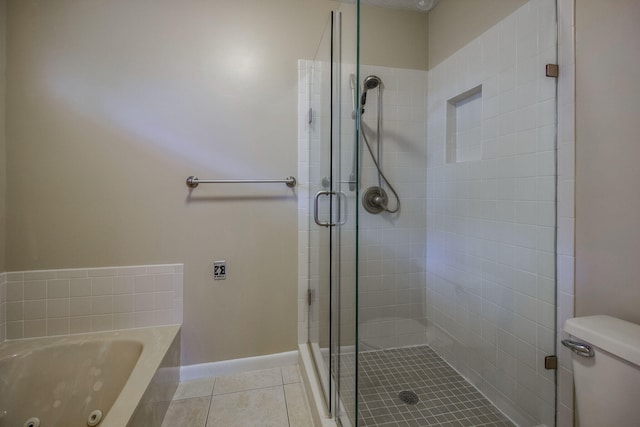 bathroom with tile patterned flooring, toilet, and plus walk in shower