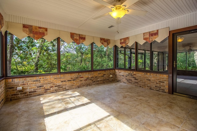 unfurnished sunroom with ceiling fan and wooden ceiling