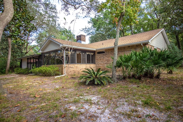 rear view of property with a sunroom