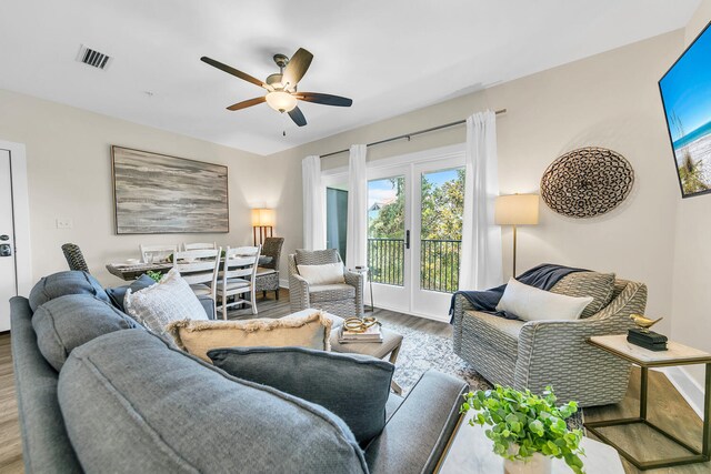 living room with ceiling fan, french doors, and hardwood / wood-style flooring