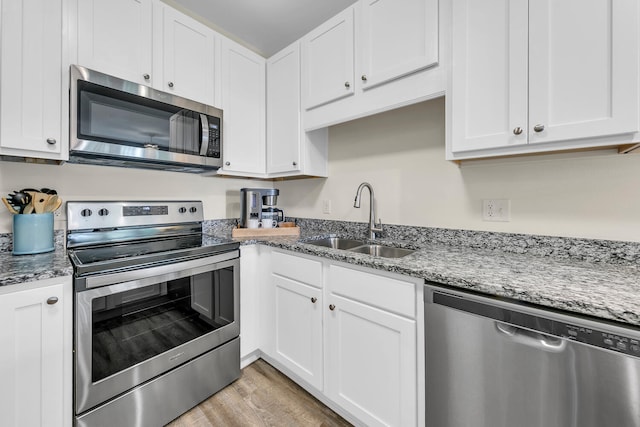 kitchen featuring white cabinets, appliances with stainless steel finishes, and sink