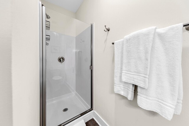 bathroom with a shower with door