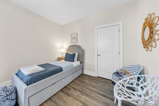 bedroom with dark hardwood / wood-style flooring