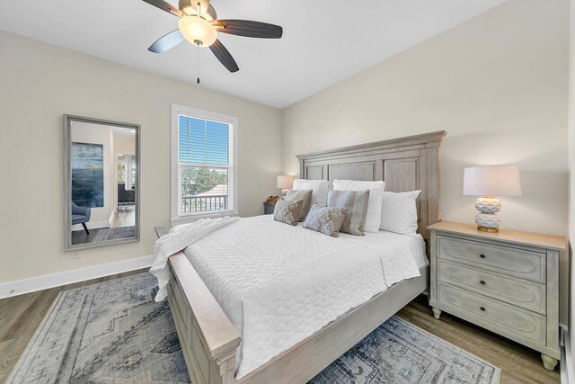 bedroom with ceiling fan and dark hardwood / wood-style floors