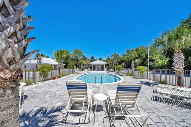 view of swimming pool featuring a patio and a gazebo