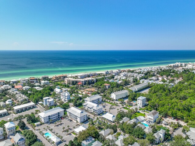 birds eye view of property with a water view and a beach view