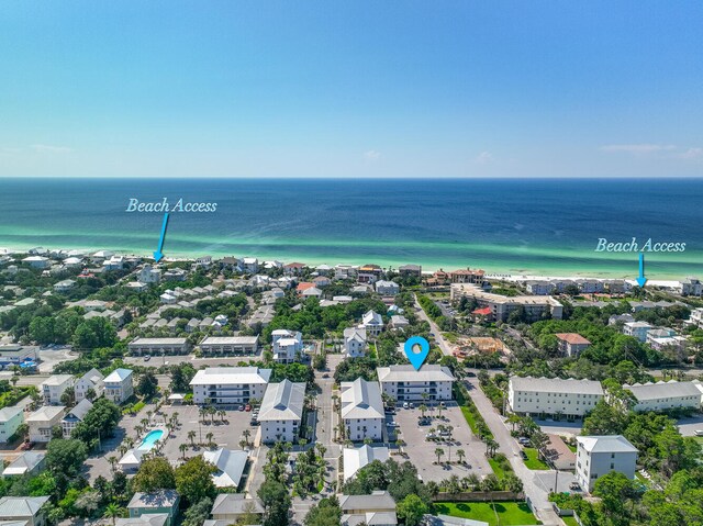 bird's eye view featuring a water view and a beach view