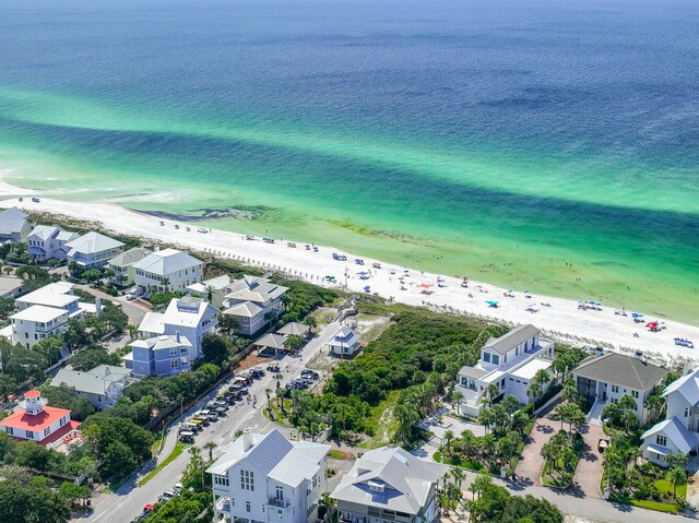 drone / aerial view with a water view and a beach view