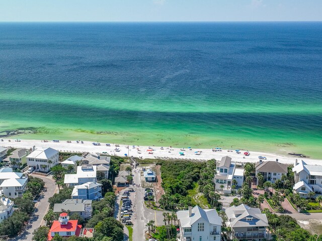 drone / aerial view featuring a water view and a view of the beach