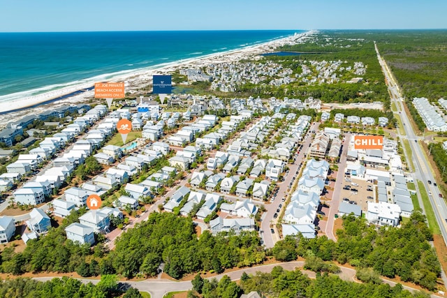 birds eye view of property featuring a water view and a beach view