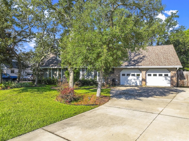 view of front of home with a garage and a front lawn