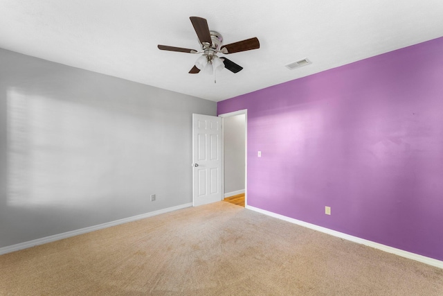 carpeted spare room with ceiling fan