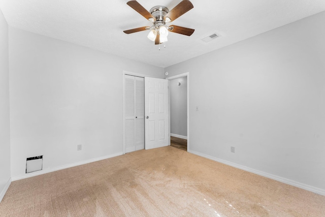 spare room featuring ceiling fan and light carpet