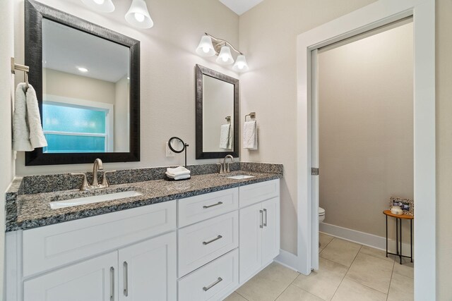 bathroom featuring vanity, toilet, and tile patterned floors