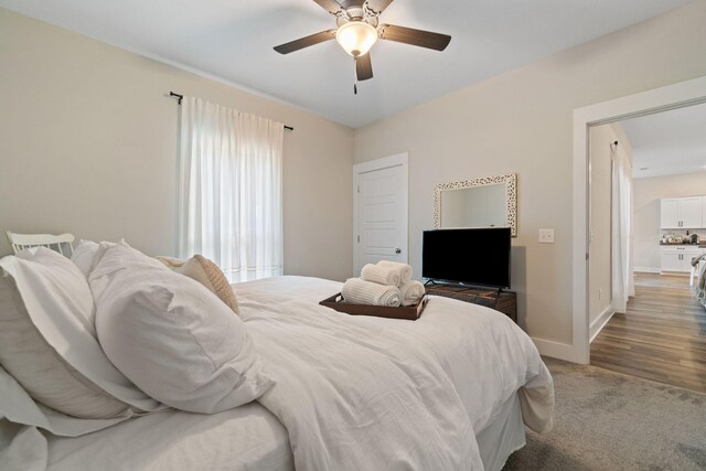 bedroom featuring ceiling fan and dark hardwood / wood-style flooring