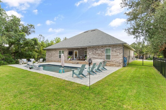 view of swimming pool featuring a yard and a patio area