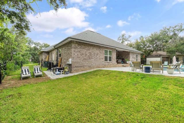 rear view of property featuring a patio area and a yard