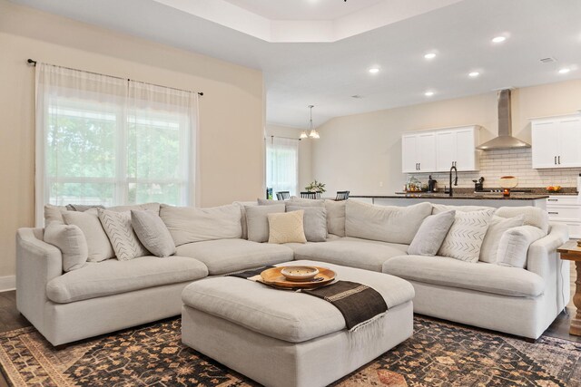 living room with dark hardwood / wood-style floors and sink