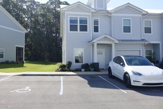 view of front of property with a garage and a front lawn