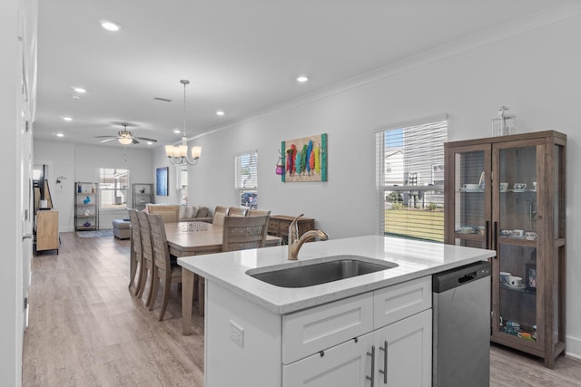 kitchen featuring white cabinetry, sink, dishwasher, light hardwood / wood-style floors, and a kitchen island with sink