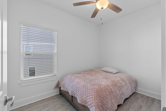 bedroom with ceiling fan and light hardwood / wood-style floors