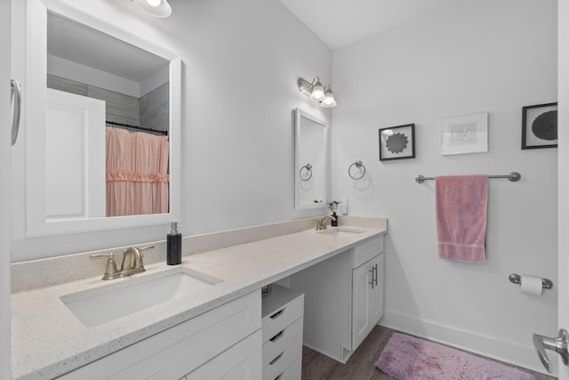 bathroom with hardwood / wood-style flooring, vanity, and a shower with shower curtain