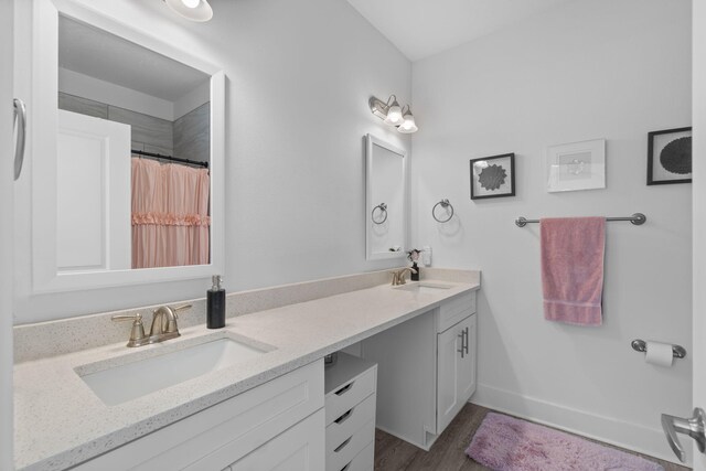 139 Date Palm Ln, Freeport, FL 32439 - full bath with double vanity, wood finished floors, baseboards, and curtained shower