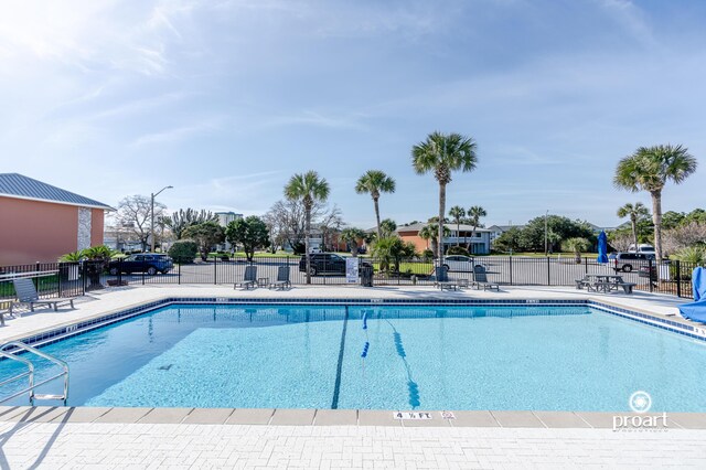 pool with fence and a patio