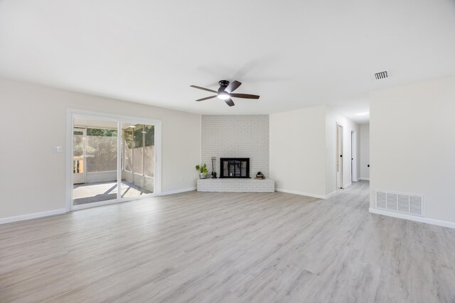 unfurnished living room with light hardwood / wood-style flooring, ceiling fan, and a fireplace