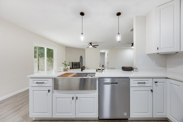 kitchen with pendant lighting, dishwasher, white cabinets, kitchen peninsula, and ceiling fan