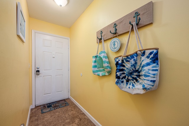 doorway to outside with tile patterned flooring