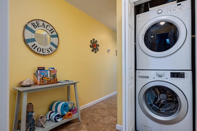 clothes washing area featuring stacked washer / drying machine and light tile patterned floors