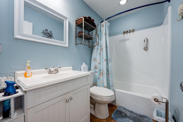 full bathroom featuring vanity, shower / tub combo, toilet, and a textured ceiling