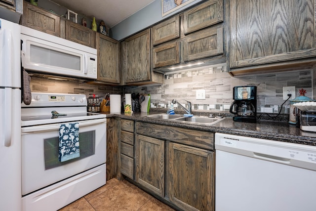 kitchen with white appliances, light tile patterned flooring, dark brown cabinetry, and tasteful backsplash