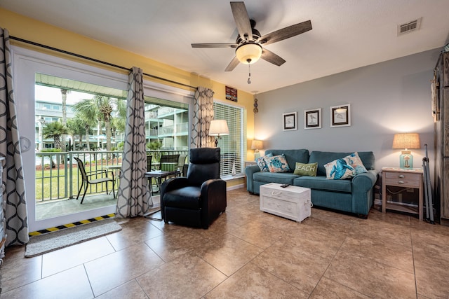 living room featuring ceiling fan and light tile patterned floors