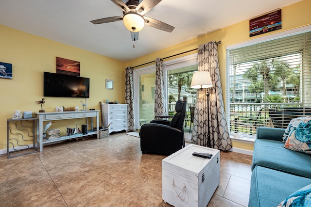 living room featuring ceiling fan and light tile patterned floors