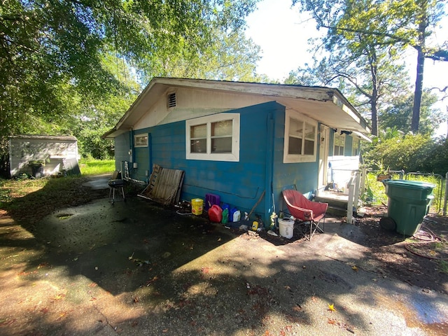 view of side of home with an outdoor structure