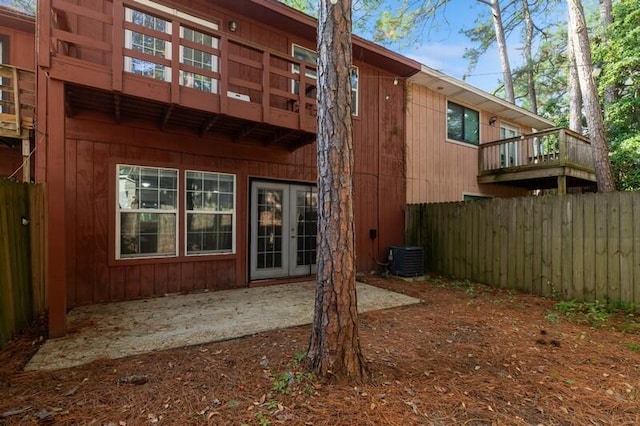 rear view of property with a balcony and fence