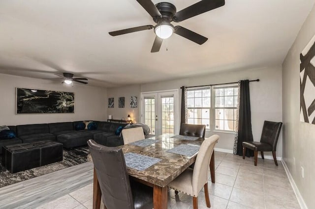 dining area with french doors, light tile patterned flooring, and baseboards