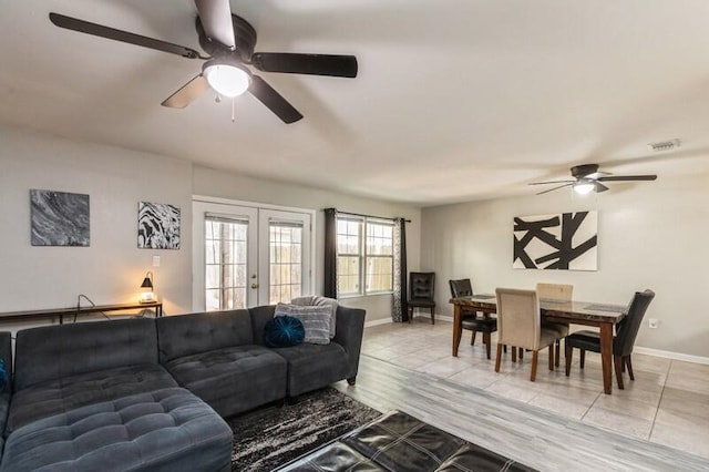 living room featuring french doors, visible vents, ceiling fan, and baseboards