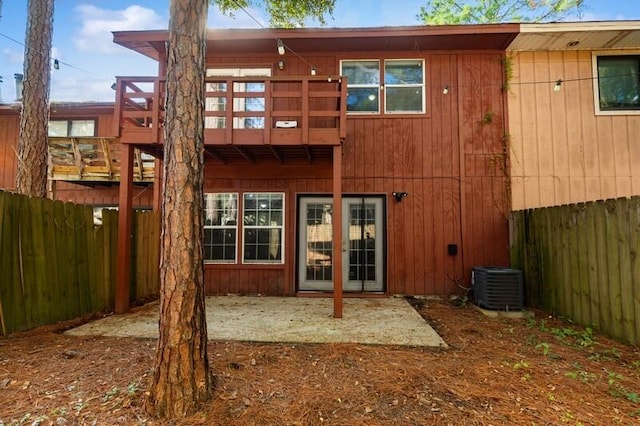 back of house featuring a fenced backyard and central air condition unit