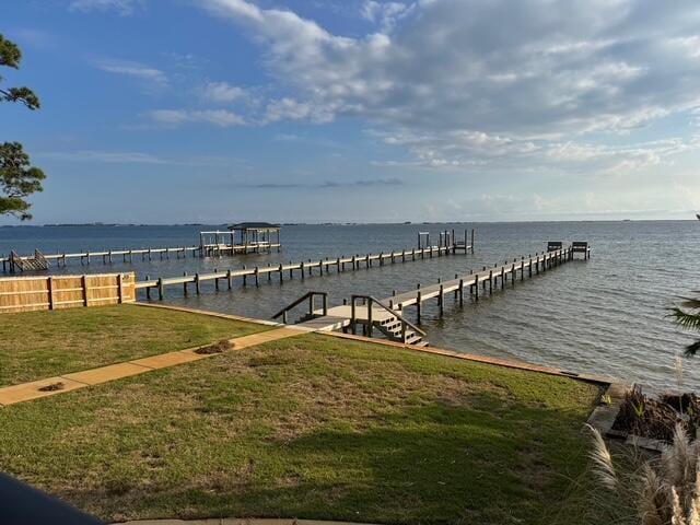 dock area featuring a water view and a yard