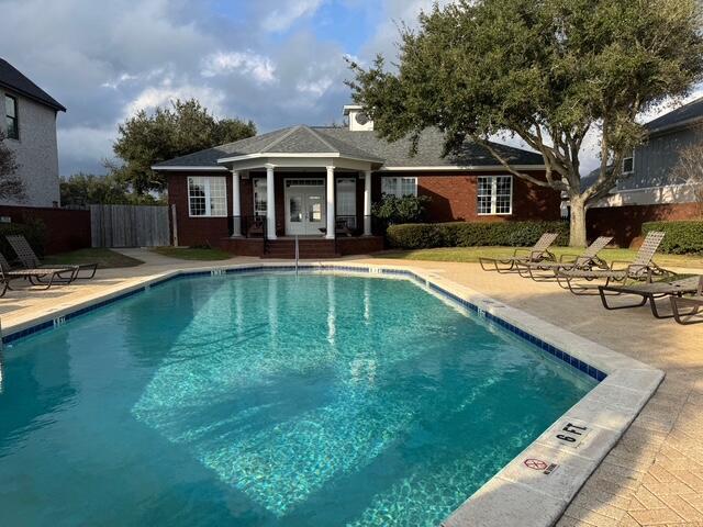 view of swimming pool with an outbuilding and a patio