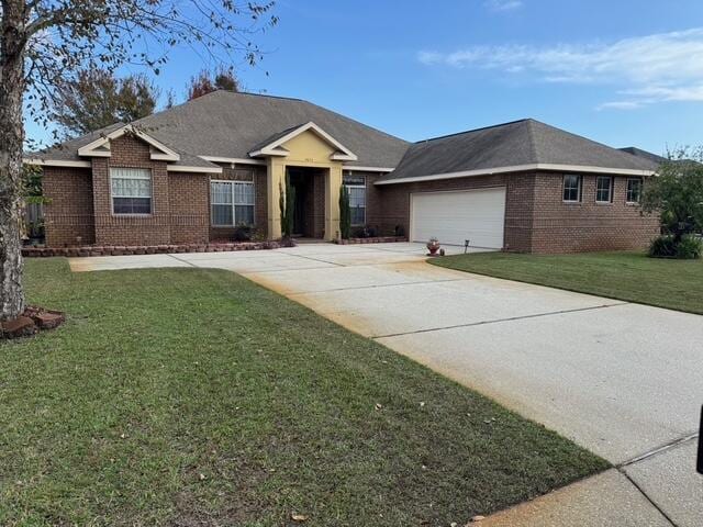 single story home with a garage and a front yard