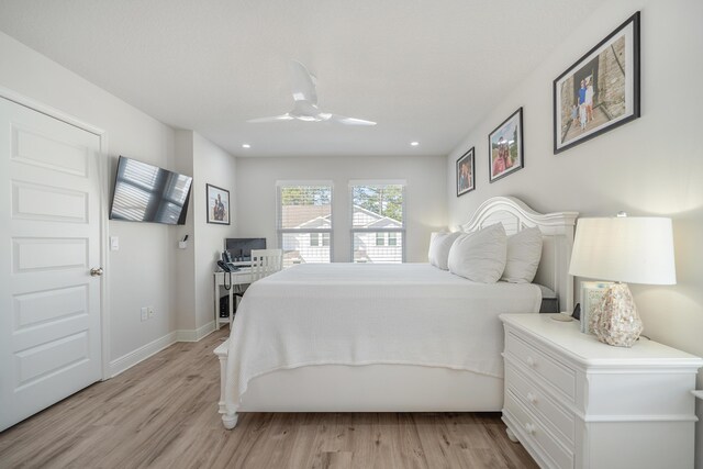 bedroom with ceiling fan and light hardwood / wood-style floors