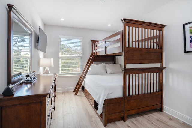 bedroom featuring light hardwood / wood-style flooring and multiple windows