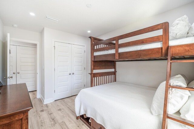 bedroom featuring light wood-type flooring and a closet