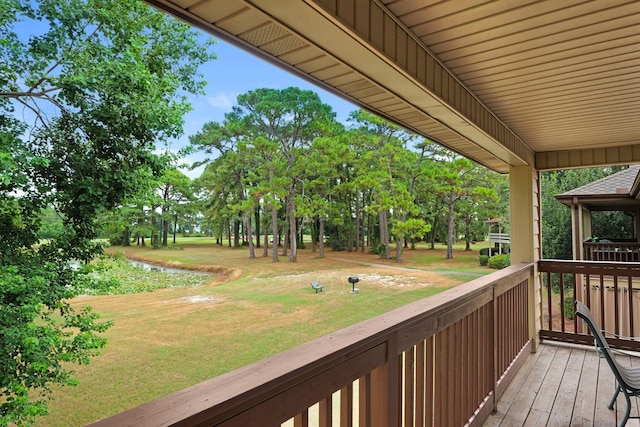 wooden deck with a lawn