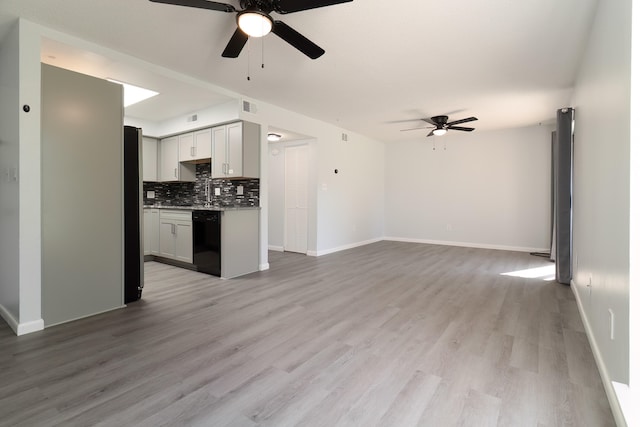 kitchen featuring gray cabinets, ceiling fan, dishwasher, tasteful backsplash, and light wood-type flooring